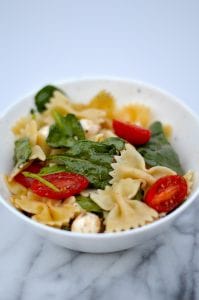 This Fresh Spinach, Tomato and Mozzarella Pasta Salad is the perfect side dish for any gathering!