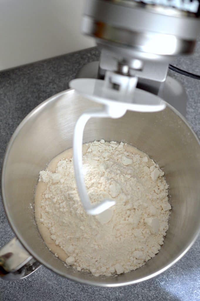 Adding flour to the yeast mixture pulls the dough for your grilled pizza all together.
