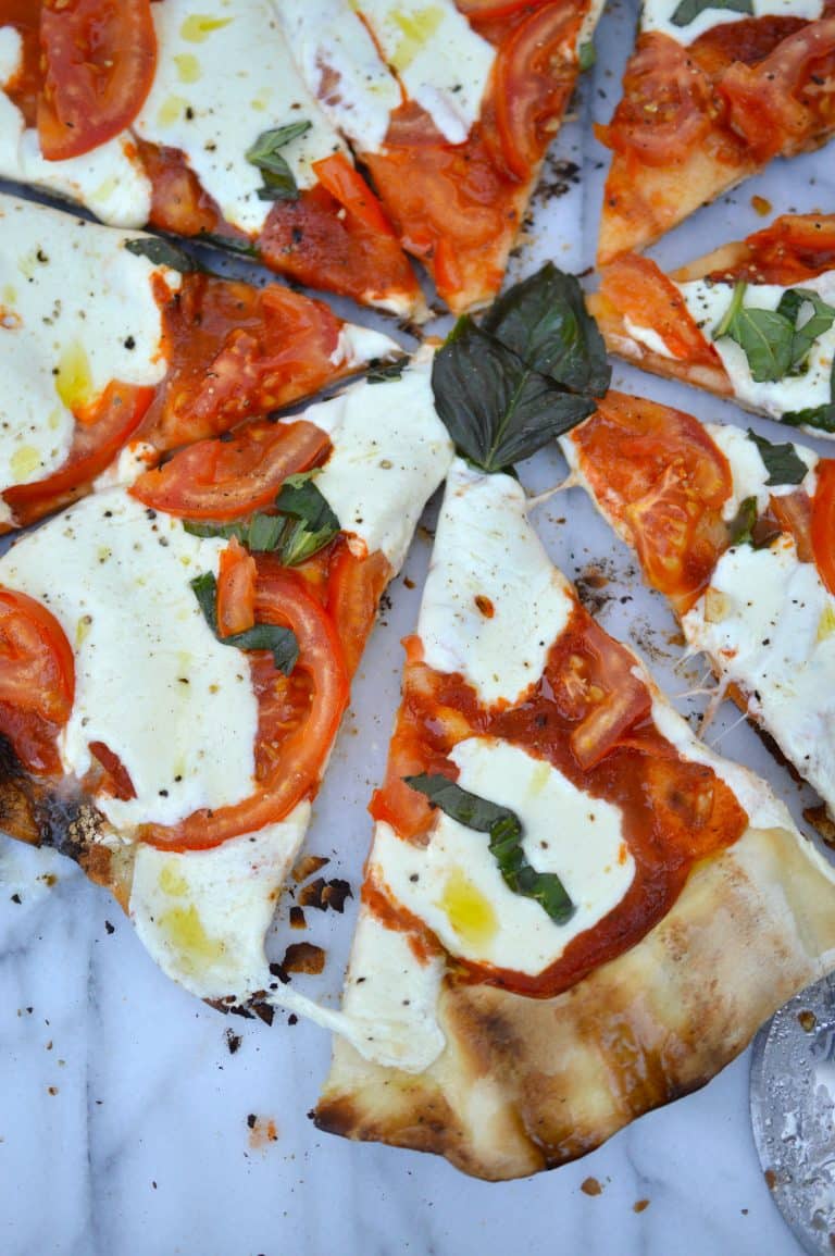 Homemade grilled pizza is perfect for when it’s just too hot to turn on the oven and you don’t want to order takeout! Crispy grilled crust holds your favorite toppings and deliciously melty cheese.