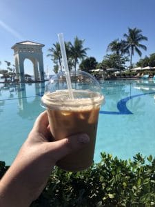 Iced caramel latte by the pool.