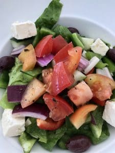 A light and refreshing Greek salad with cucumbers, lettuce, tomatoes, onions and feta cheese.