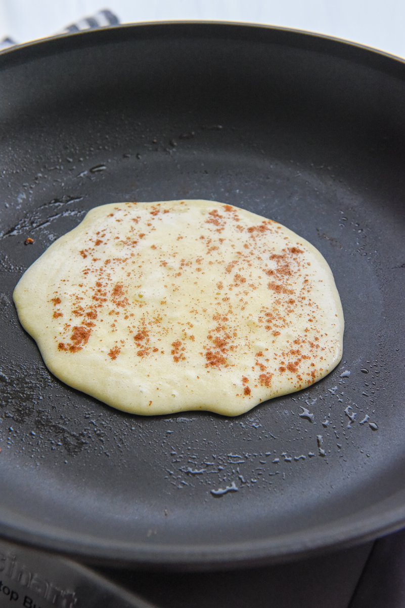 Healthy banana pancake on a pan waiting to be flipped.