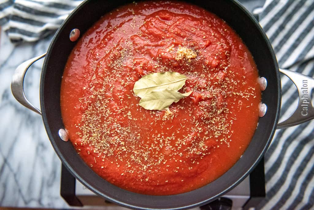 Tomato sauce and herbs simmering in a saucepot